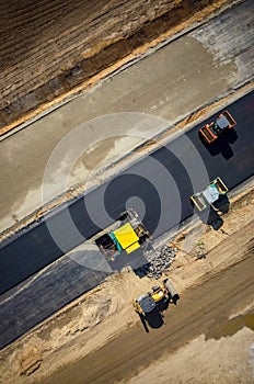 Road rollers working on the construction site aerial view