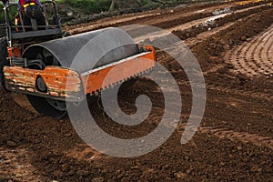 Road rollers working on the new roads construction site. Heavy duty machinery working on highway. Construction equipment