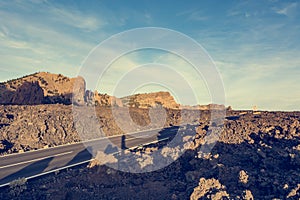 Road running through lava formed volcanic wasteland.
