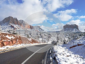 Road running through the snow-covered Red Buttes of Arizona