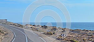 The road runs along the sea