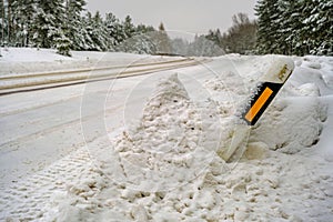 Road safety checkpoint on a winter day. Snow removal equipment damaged the post