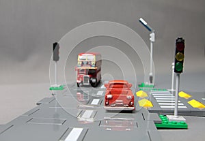 Road safety concept - crossroad model with traffic signs and cars