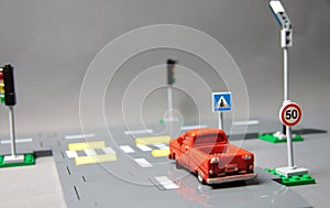 Road safety concept - crossroad with traffic signs and a car