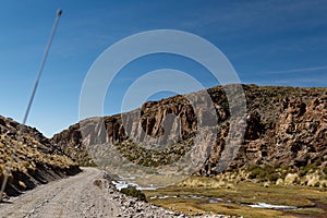 Road by the season river in Altiplano Boliviano