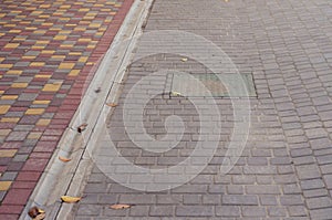 Road and sidewalk covered with colorful paving tiles. Green manh photo