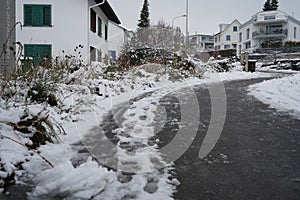 Road and sidewalk in street of Urdorf in Switzerland in winter.