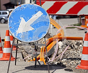 Road sign with arrow white before excavation for the laying of t