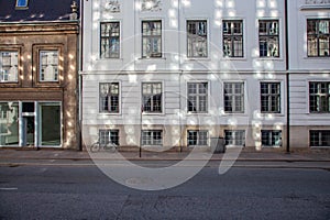 road sign and bicycle near old houses on empty street