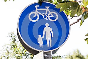 Road sign for bikes and pedestrians. Blue round traffic sign for safety.