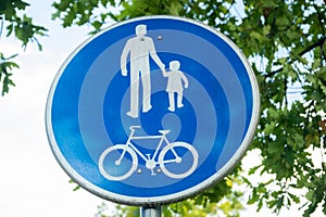 Road sign for bikes and pedestrians. Blue round traffic sign for safety