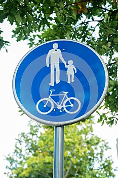 Road sign for bikes and pedestrians. Blue round traffic sign for safety