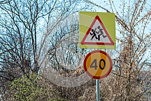 Road sign Caution children and speed limit 40.