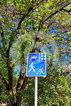 Road sign `Caution children` on the street.