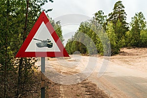 Road sign caution tanks on a country road in the woods