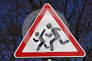 Road sign cautious children. Driver's warning about people running