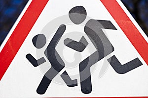 Road sign cautious children. Driver's warning about people running