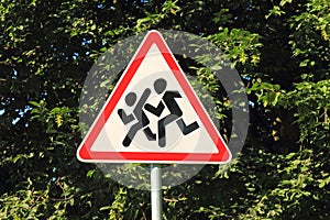 Road sign Children, against a tree in a shadow