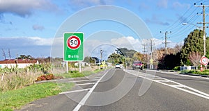 Road sign designating a fifty kilometre per hour speed zone travelling through the town of Bulls