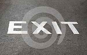 Road sign exit at asphalt texture surface