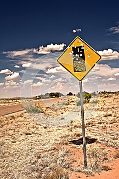 Road sign full of shotgun holes