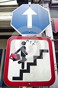 Road sign with glamor woman stair