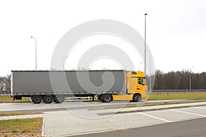 Road sign on the highway. safety of traffic. Motor transportation of passengers and cargoes. Modern cars. A large truck is moving