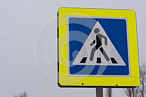 A road sign indicating a pedestrian crossing.