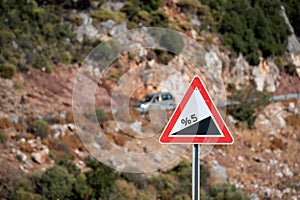 Road sign informing about steep rise on the mountain serpentine