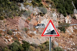 Road sign informing about steep rise on the mountain serpentine photo