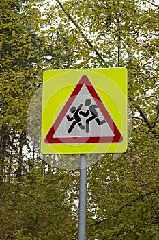 Road sign, installed near schools. Be careful, children. Yellow square, with a red triangle, white, with the image of