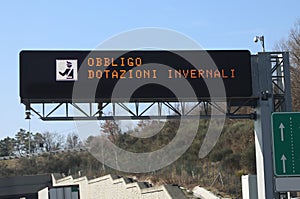 Road Sign in Italian language that menas winter equipment obliga photo
