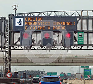 road sign in Italian meaning obligation of winter equipment and speed cameras for speed detection photo