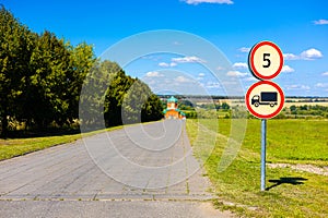 road sign limiting the speed of movement and the passage of heavy vehicles