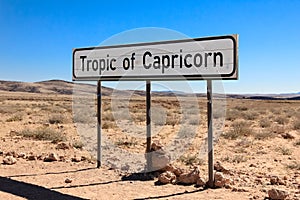 Road sign marking the Tropic of Capricorn in the desert.