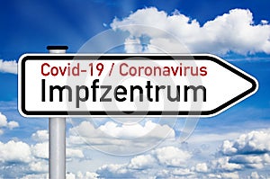 Road sign with medical touchscreen and the german word for covid-19 vaccination center or centre - impfzentrum isolated