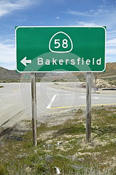 A road sign near Bakersfield California pointing to Route 58 to Bakersfield