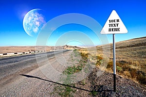 Road sign near the highway and planet