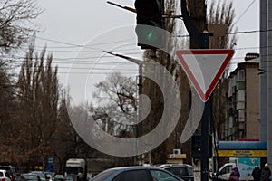 A road sign obliging to give way when crossing an intersection. photo