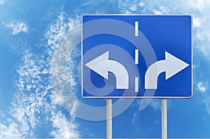 Road sign with opposite arrows on two rod and sky backgrounds