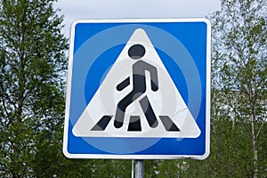 Road sign pedestrian crossing. Zebra crossing, pedestrian cross warning traffic sign in blue and pole