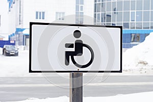 Road sign - place for invalid disabled people in parking lot in city.