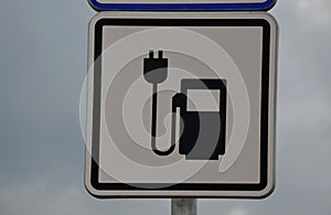 Road sign reservations for electric cars. Charging station with petrol stand symbol with cable and plug for electric battery charg