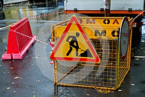 Road sign of road works and fencing around street works. Sign of road works in the city