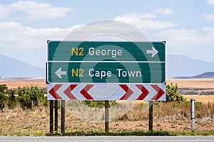 Road sign at the route N2 road in South Africa near Still Bay pointing to Cape Town and George.