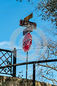 Road sign saying dead end and stop on the corner of east arsenal and washington street in san antonio texas near railing