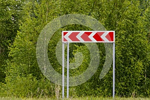 Road sign sharp turn on green background.