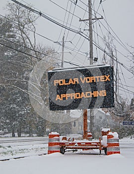 Road sign in snow warning of polar vortex