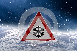 Road sign snow warns of snow and ice in winter, warning sign