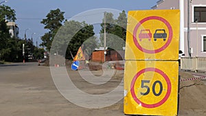 Road sign speed limit 50 km h in combination with road work ahead. Warning signs for work in progress on closed road